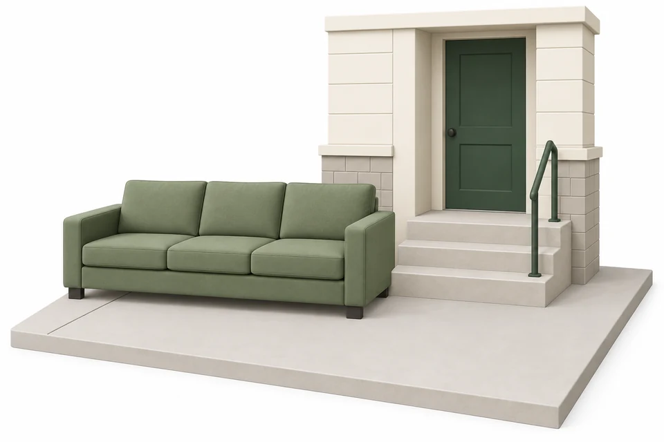 Sofa outside beside an apartment entrance, with a clear ground-level path.