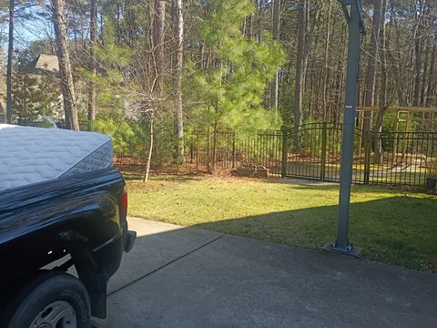 Customer photo: the mattress loaded into the pickup, with its former spot clear.